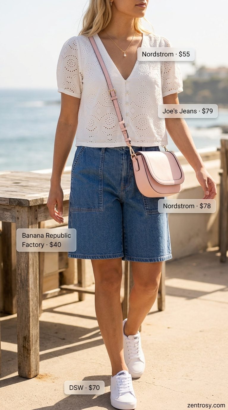 Cute summer beach outfit for women 2026: White eyelet blouse, denim shorts, pink crossbody bag, gold necklace, and sneakers.