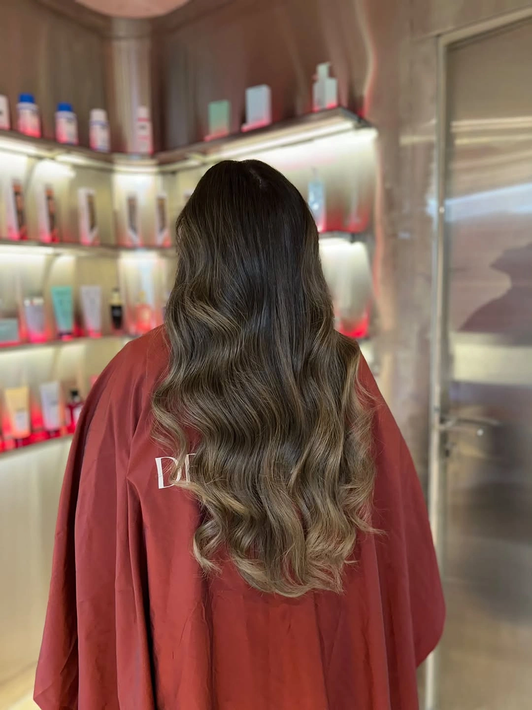 Long dark brunette waves with warm brown ribbons through the lower lengths