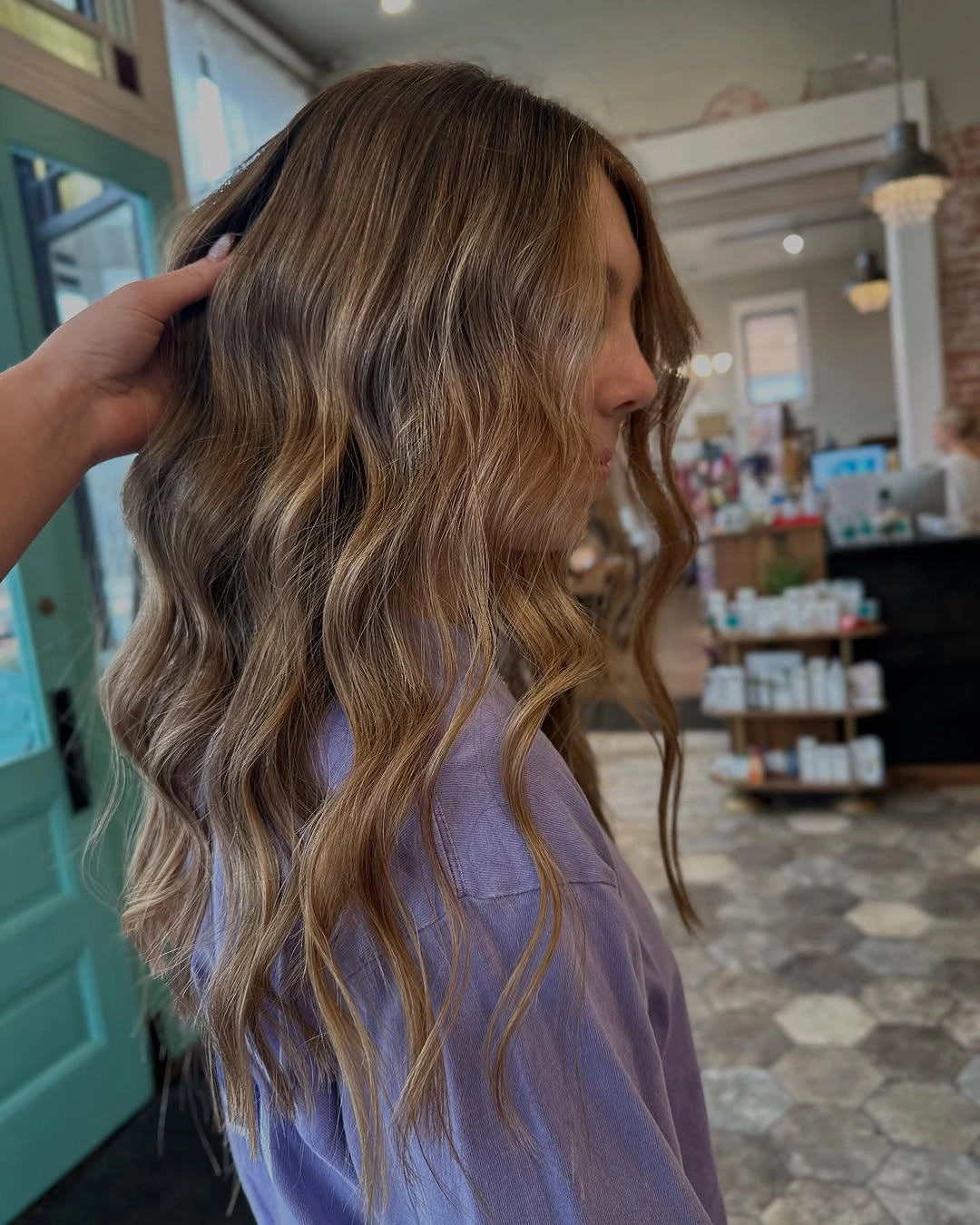 Long medium brown waves with honey caramel strands around the face and lengths