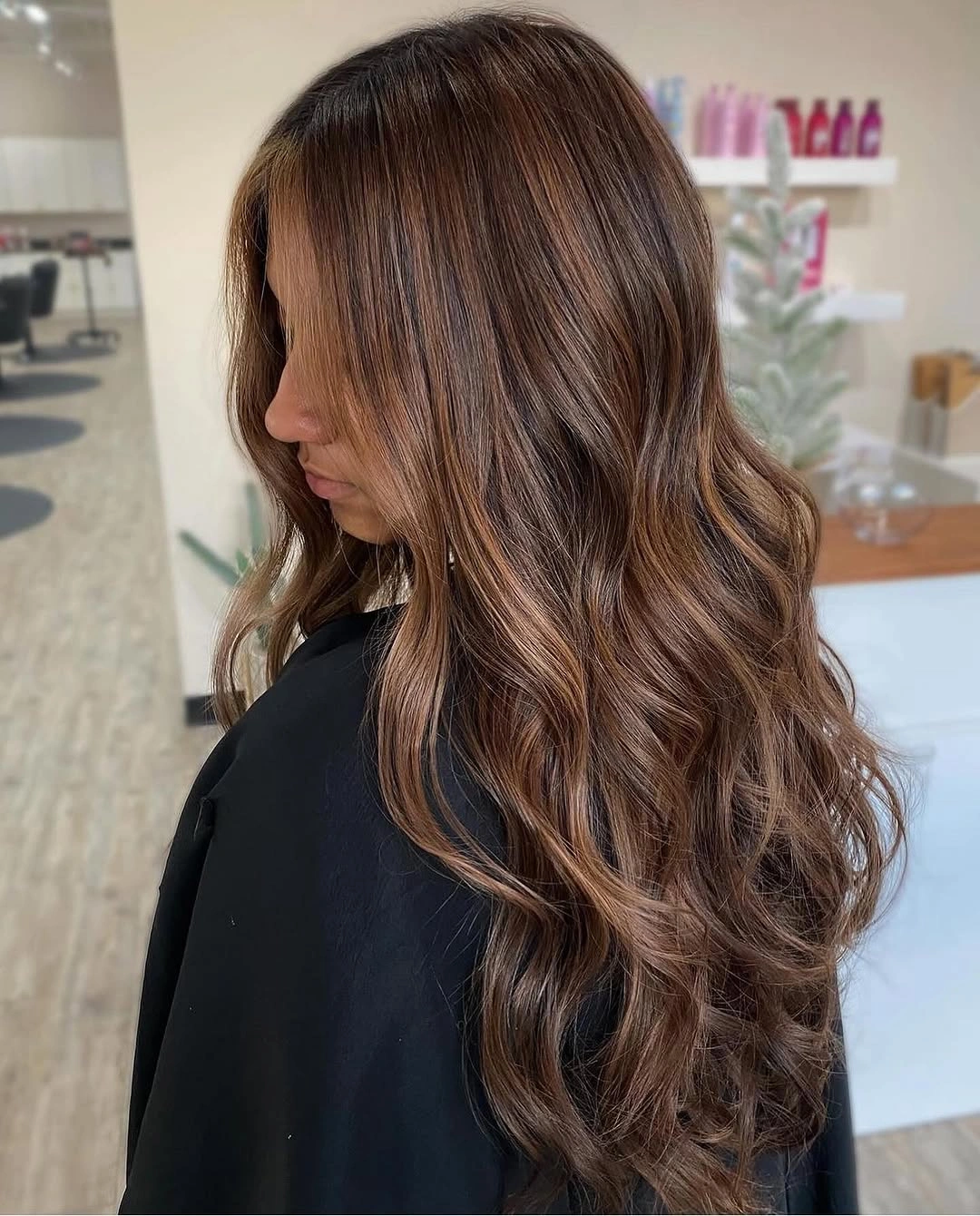 Long rich brown waves with narrow caramel ribbons across the side and back