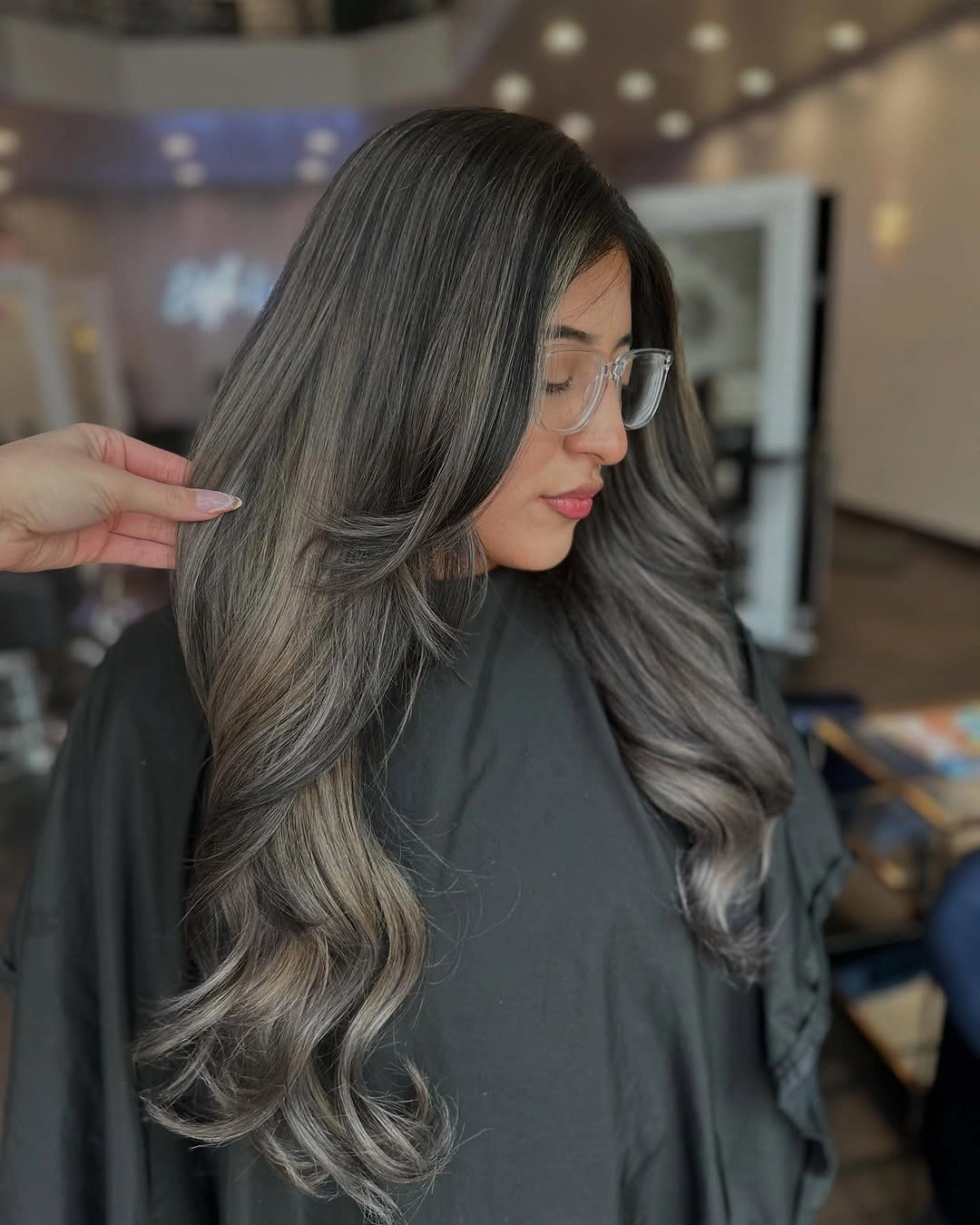 Long ash-gray brunette waves with dark roots and gray-beige lengths