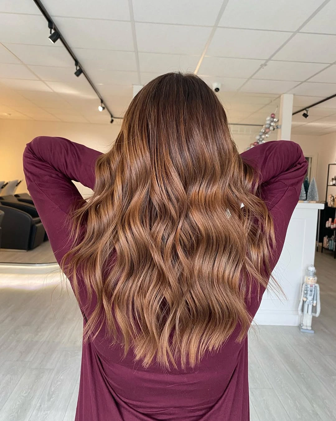Long warm caramel brown waves with lighter golden brown ribbons throughout