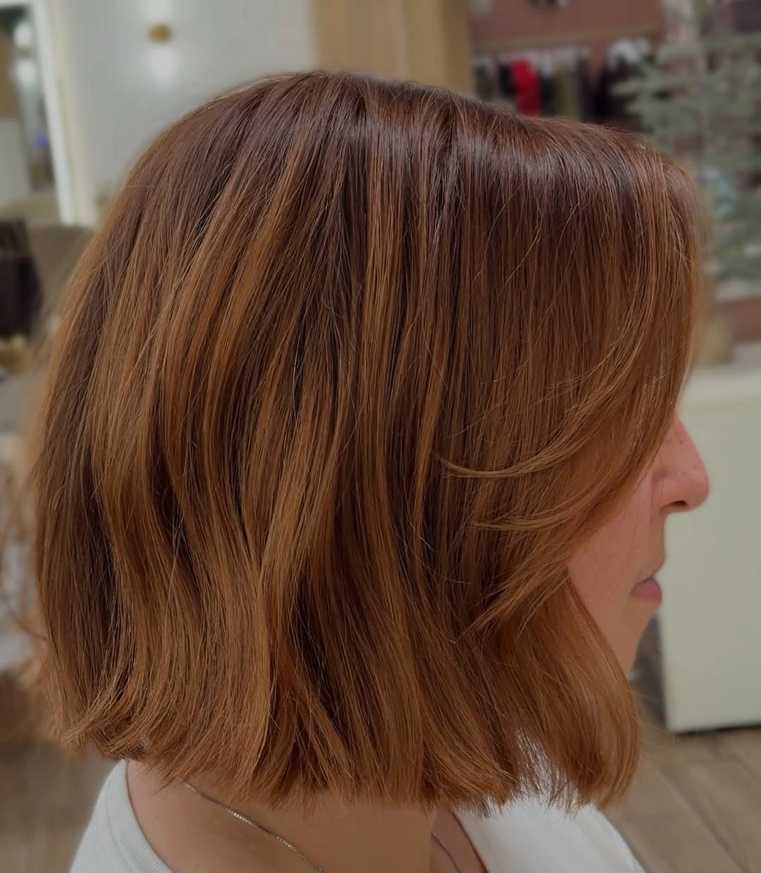 Short copper auburn bob with warm reddish strands and textured ends