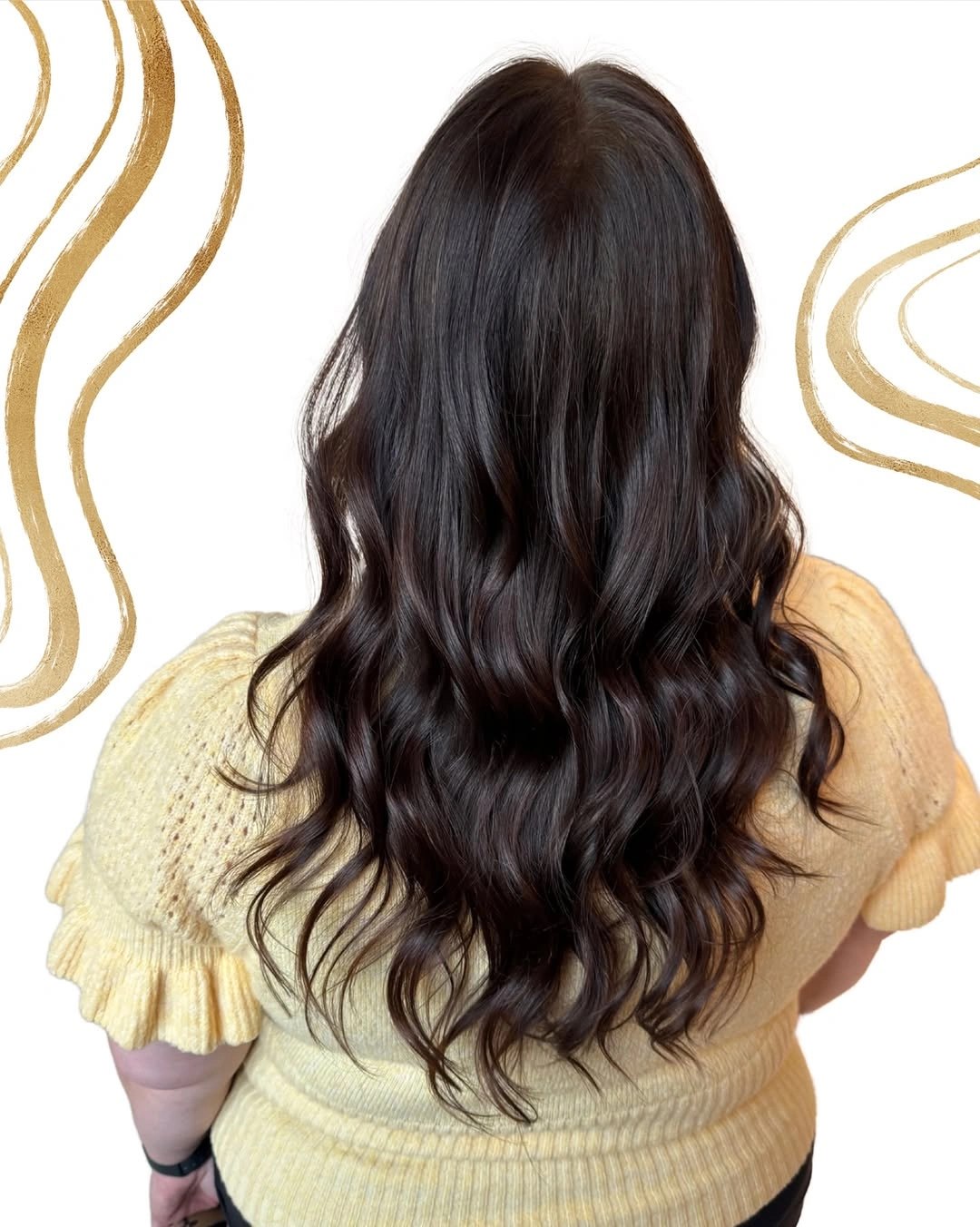 Long glossy near-black brunette hair falling into soft loose waves