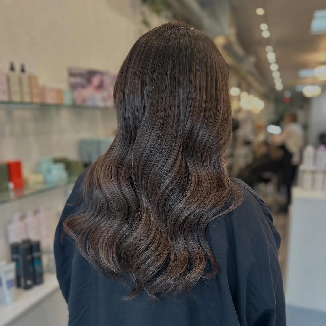 Long muted medium-brown waves with subtle ashy color variation