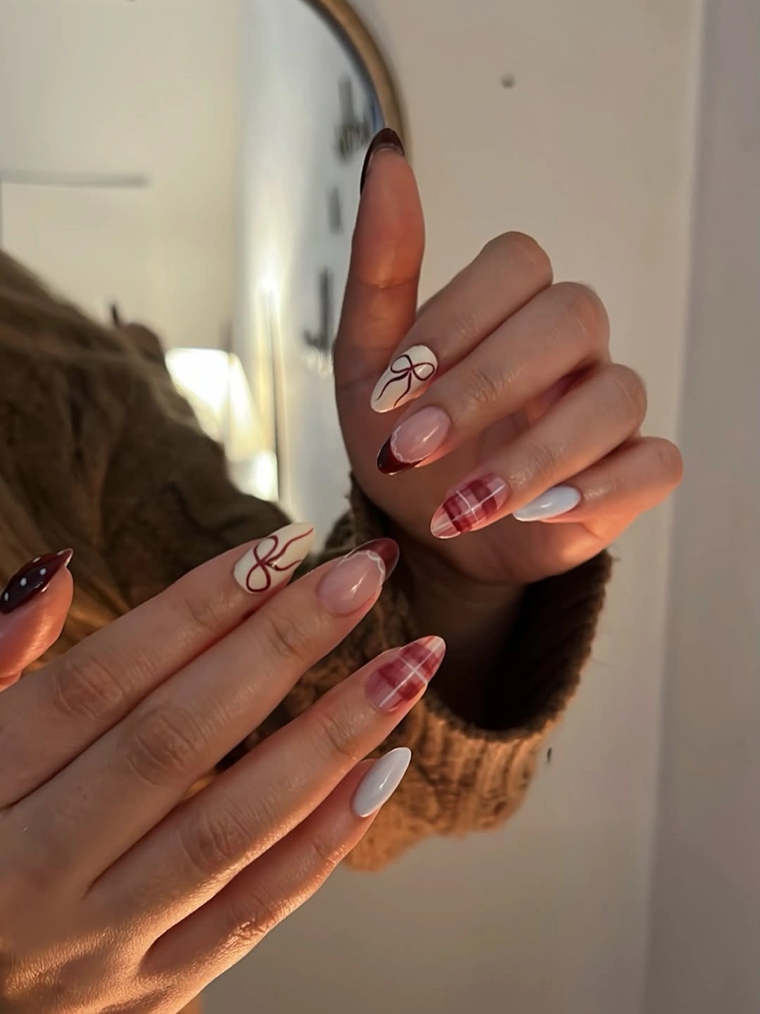Long tapered nails with red plaid patterns and delicate bow outlines