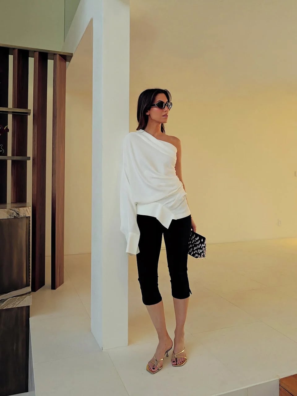 Black Capris with an Asymmetrical White Top and Gold Heeled Mules — Elegant Black Capri Pants Outfit