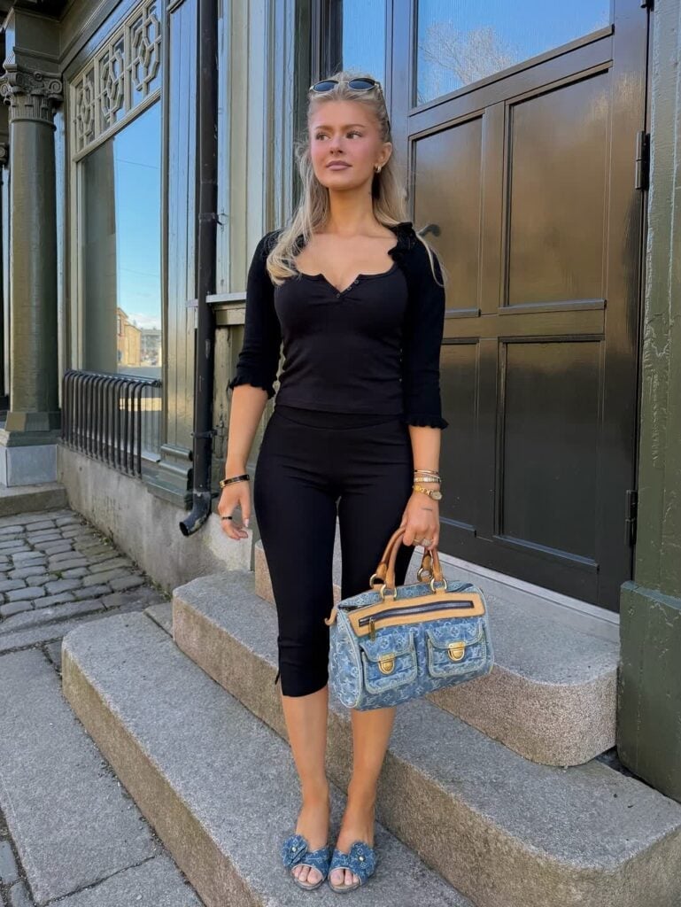 Black Capris with a Ruffled Neckline Top and Denim Accessories — Elegant Black Capri Pants Outfit