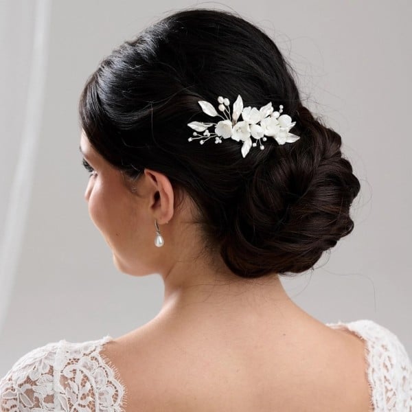 Low Dark Brown Chignon With Floral Accessory — Elegant Updo Inspo