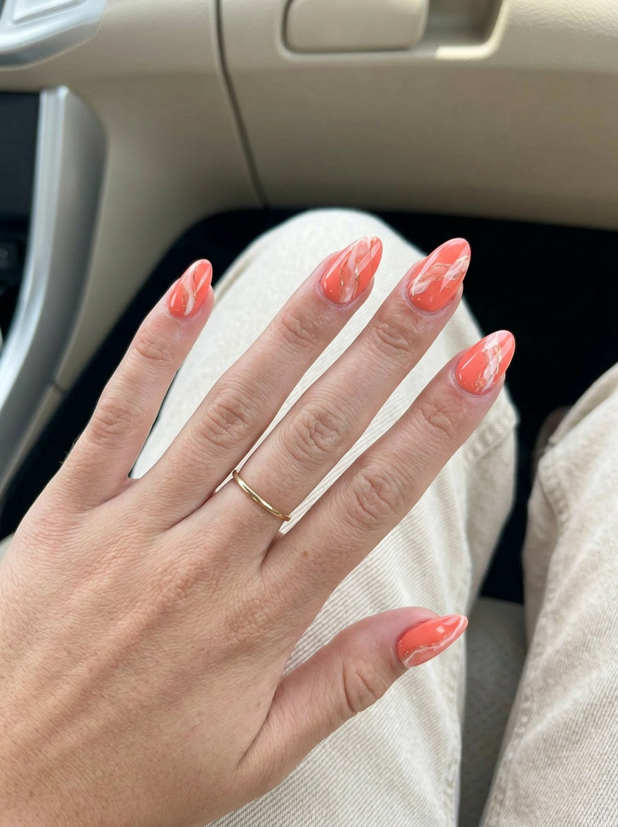 Sophisticated artistic coral marble manicure, a vibrant summer trend for 2026. Ideal for vacations.