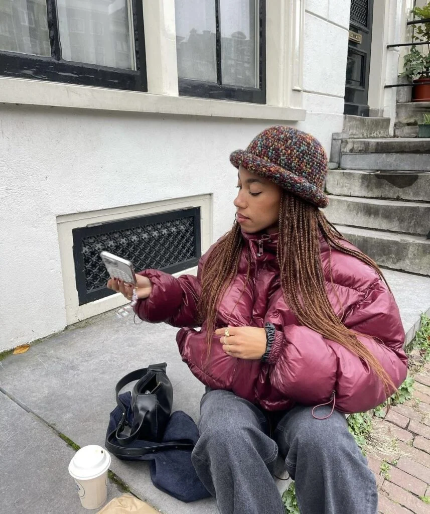 Shiny Burgundy Puffer Jacket with Knit Hat and Wide-Leg Jeans — Winter Puffer Jacket Outfits