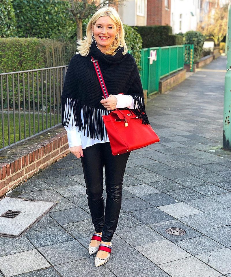 Black Fringed Poncho over White Shirt with Strappy Heels — Winter Outfits for Women Over 60