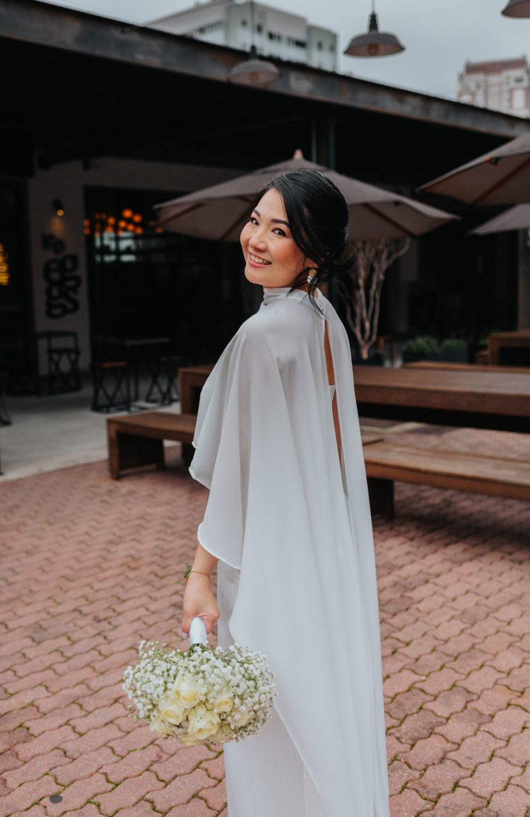 Monochromatic White Ensemble with a Dramatic Chiffon Cape — Winter Wedding Guest Outfits