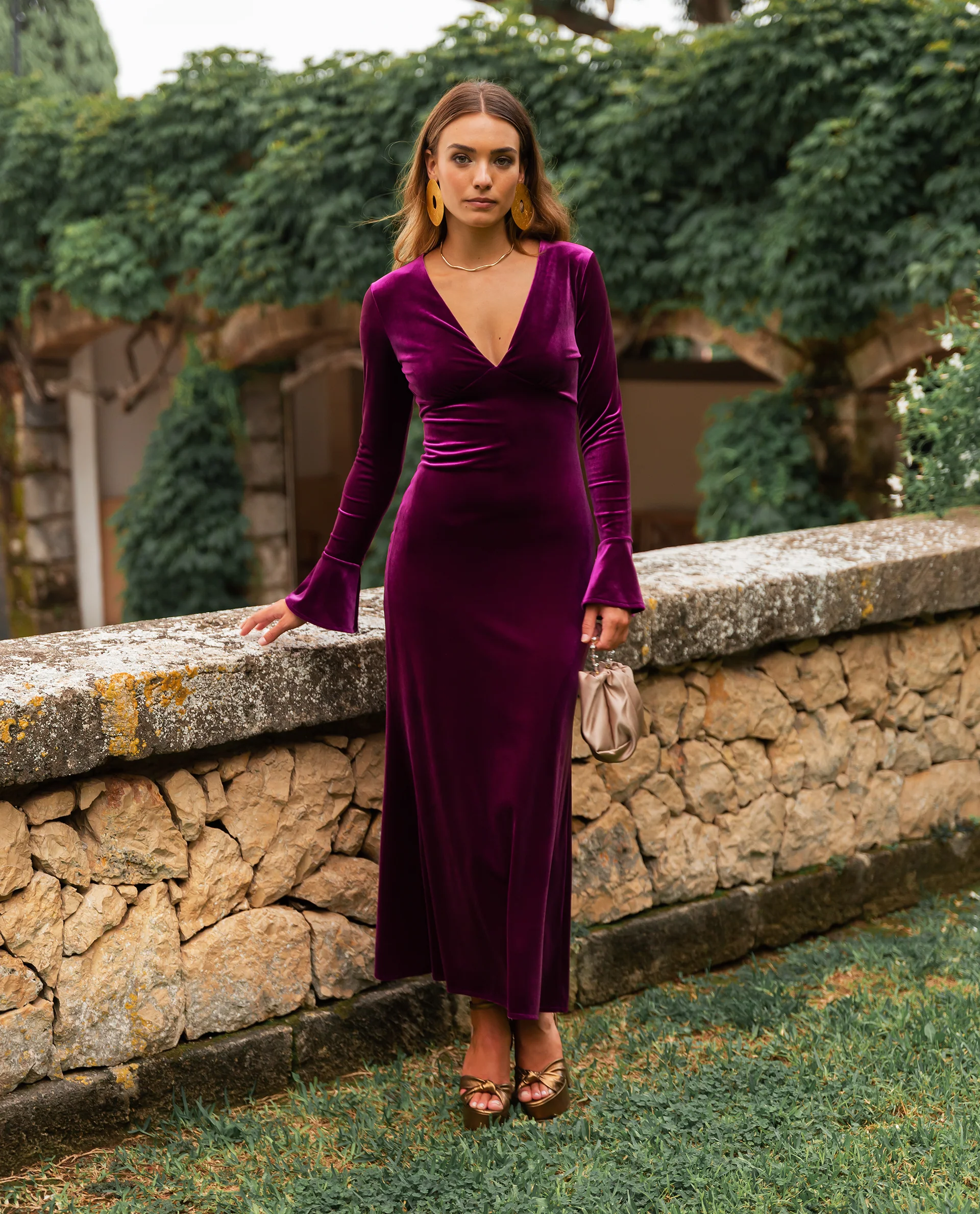 Deep Purple Velvet Maxi Dress with Bell Sleeves and Gold Accents — Winter Wedding Guest Outfits