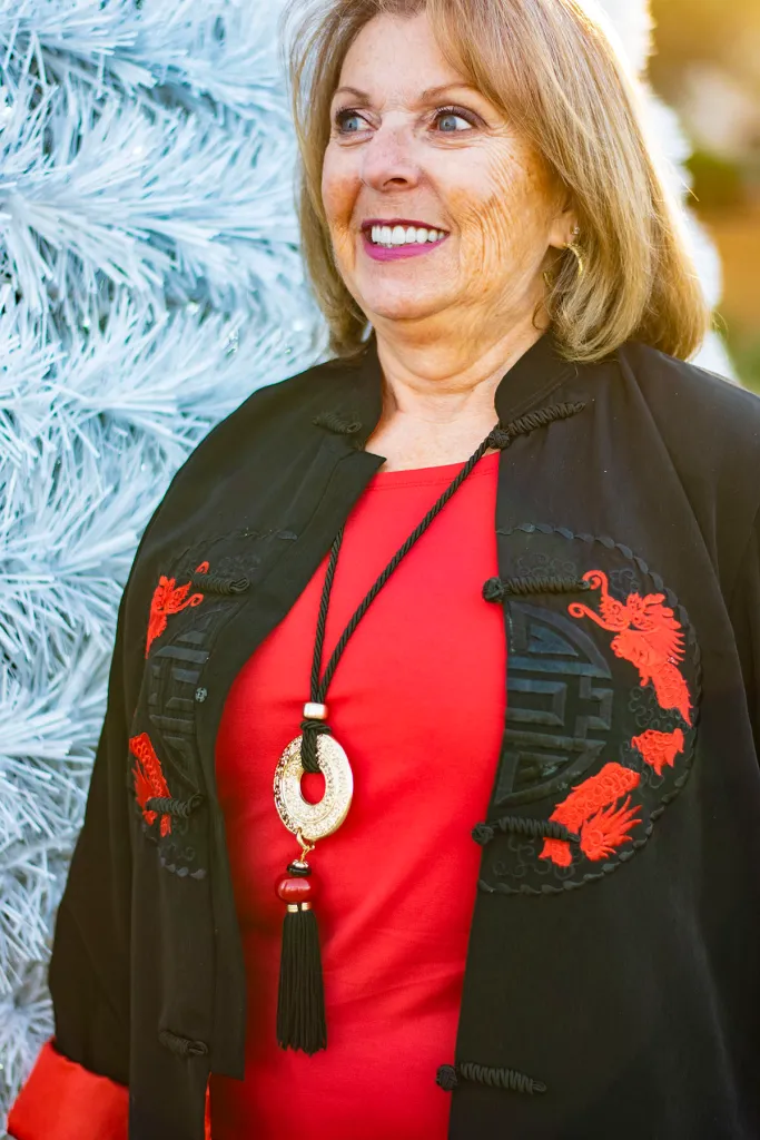 Embroidered Black Jacket Over a Vibrant Red Top — Winter Outfits for Women Over 70