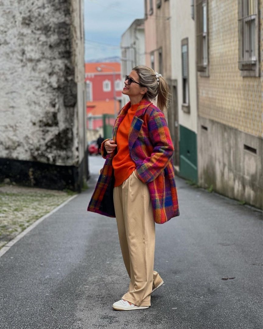 Vibrant Plaid Coat Over Orange Sweater Creates a Joyful Winter Look — Colorful Winter Outfits