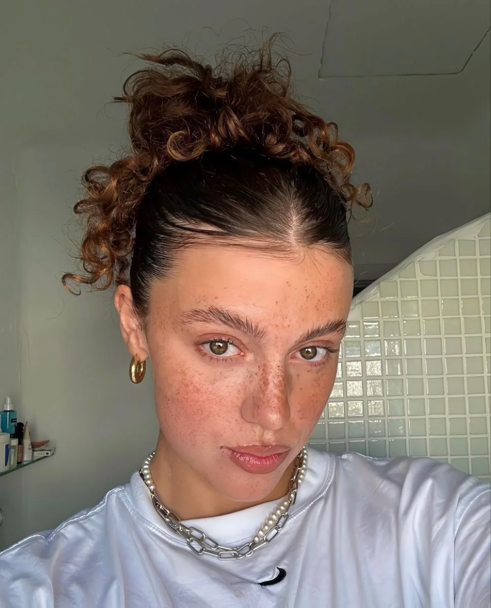 Messy Bun With Auburn Highlights — Winter Hairstyles for Work