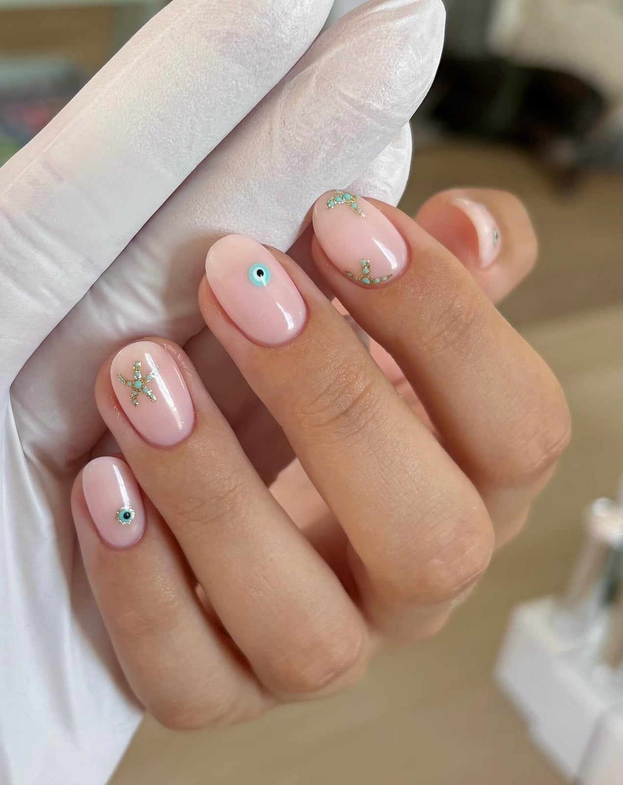Short Almond Milky Pink Gold Glitter Evil Eye Charms — Nail Art Ideas