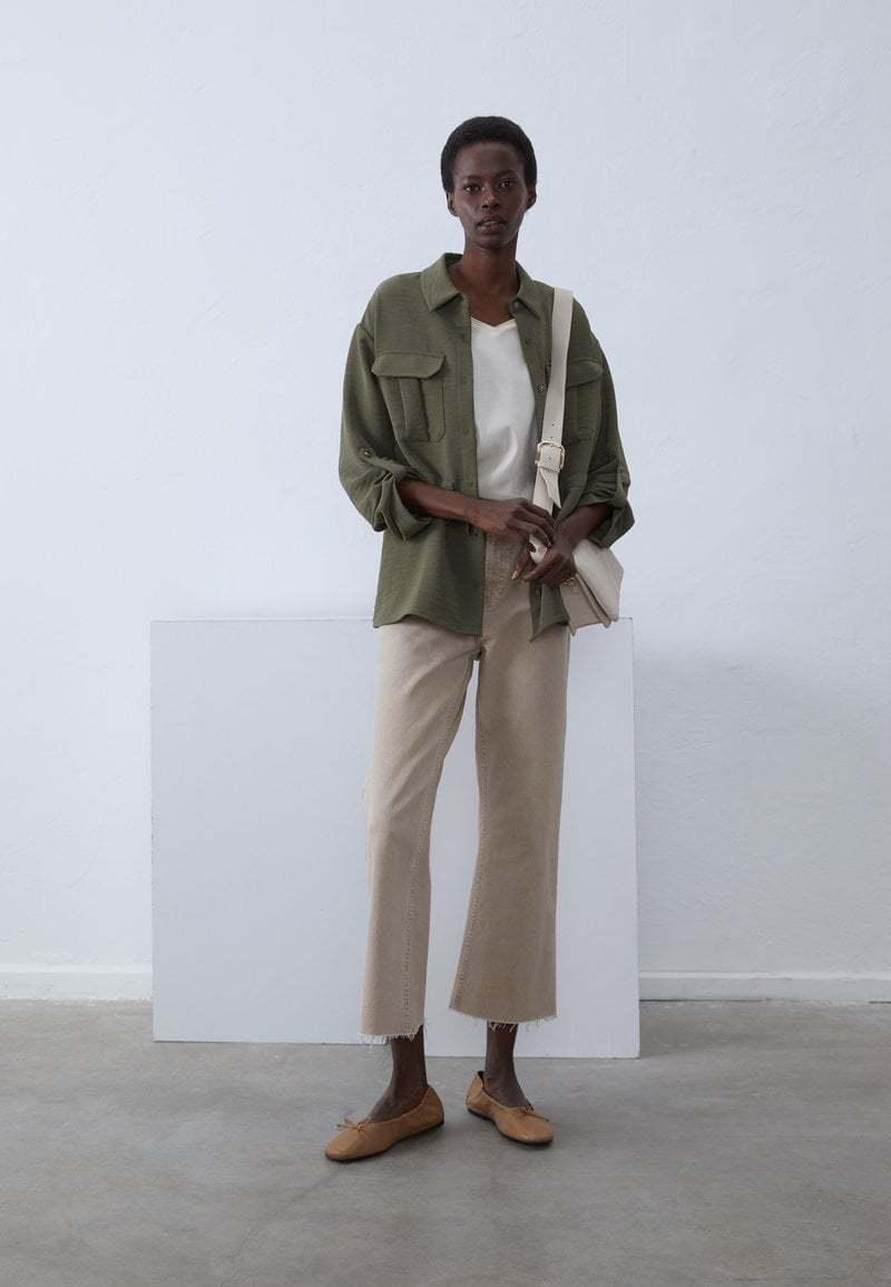 Olive Green Utility Shirt Over White T Shirt With Beige Pants — Simple Button Down Outfits