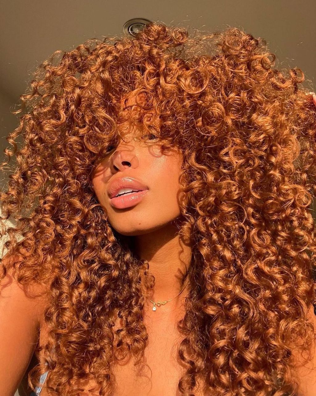 Vibrant Cinnamon Mid-Back Curls With Full Fringe — Simple Cinnamon Hair Color