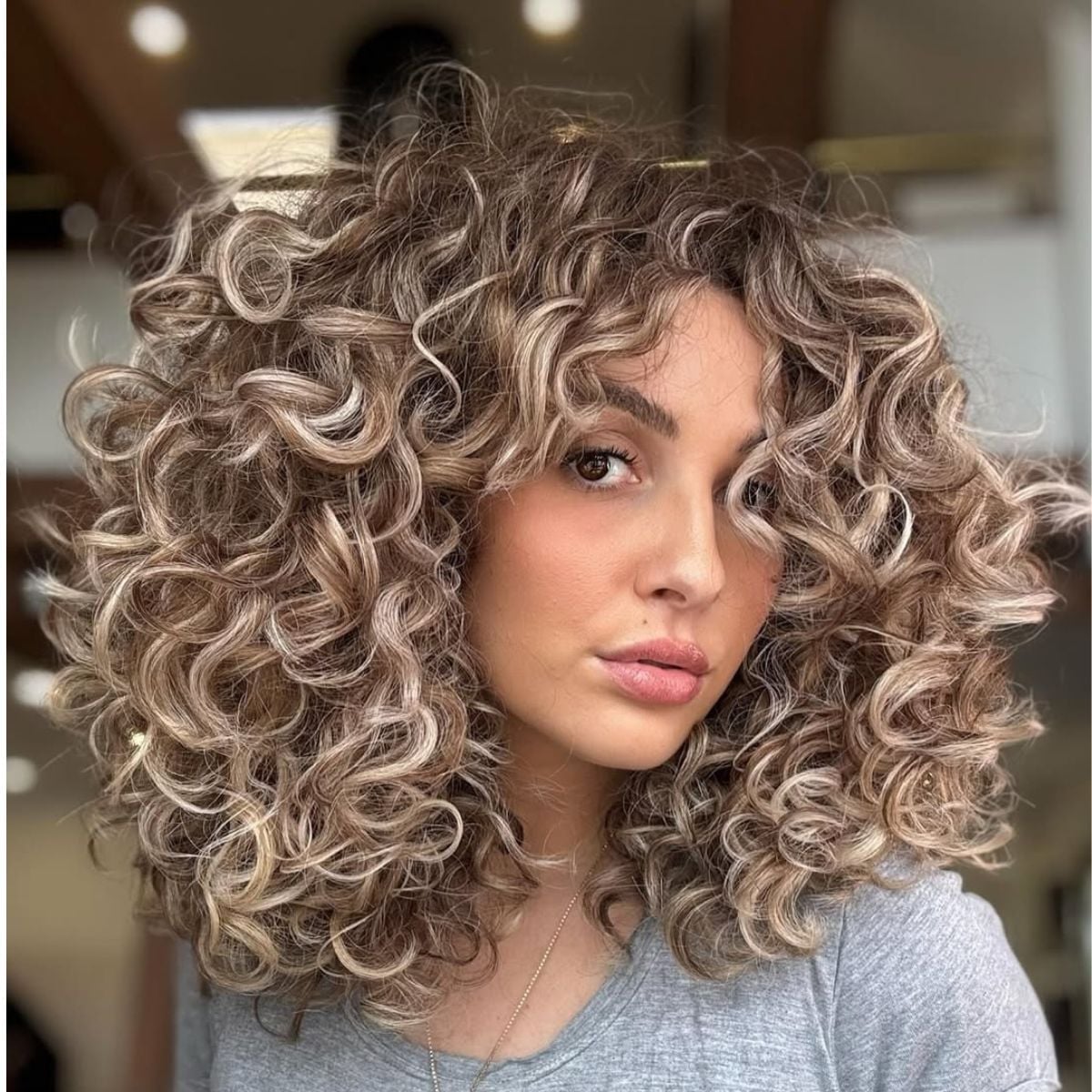 Voluminous Blowout With Dark Blonde Curls — Simple Curly Hair Cuts
