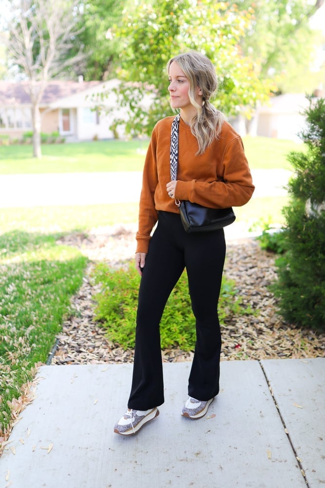 Orange Cropped Sweatshirt with Black Flare Leggings and Fitted Top — Simple Flare Leggings Outfits