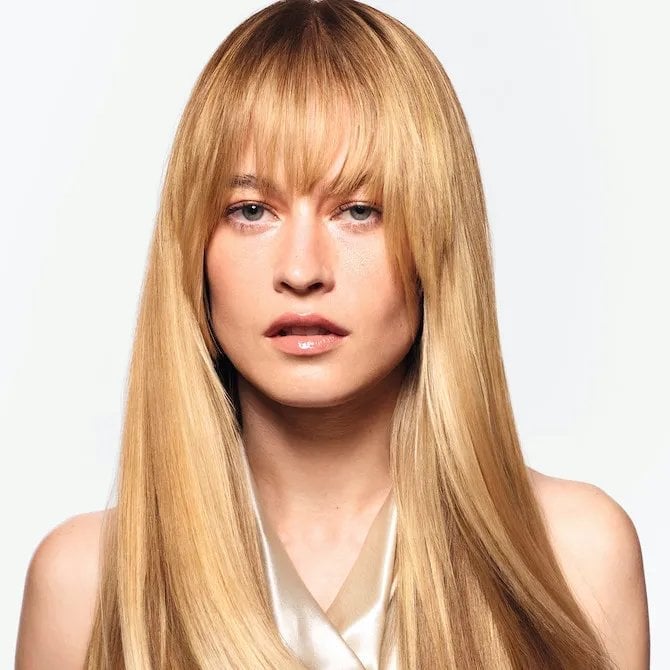 Mid-Back Golden Blonde Balayage With Waves and Curtain Bangs — Simple Hair Color for Pale Skin