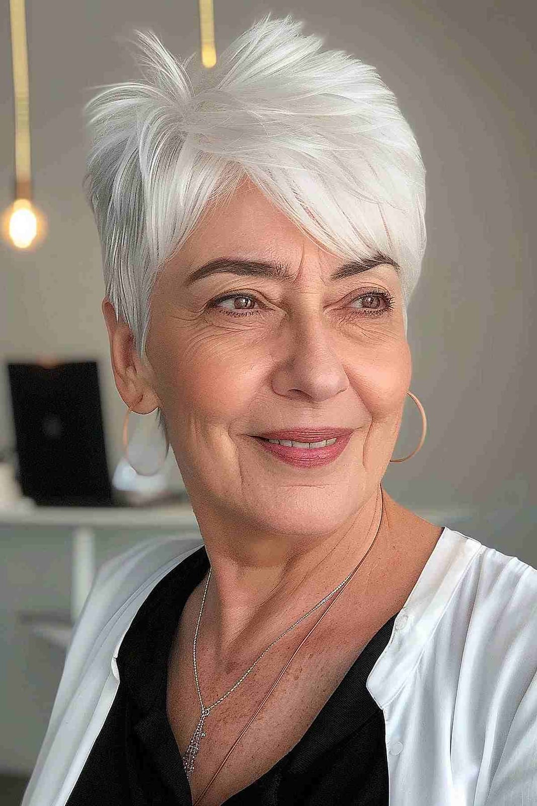 Voluminous White Blonde Pixie With Side Swept Bangs, Ear — Simple Haircuts for Older Women