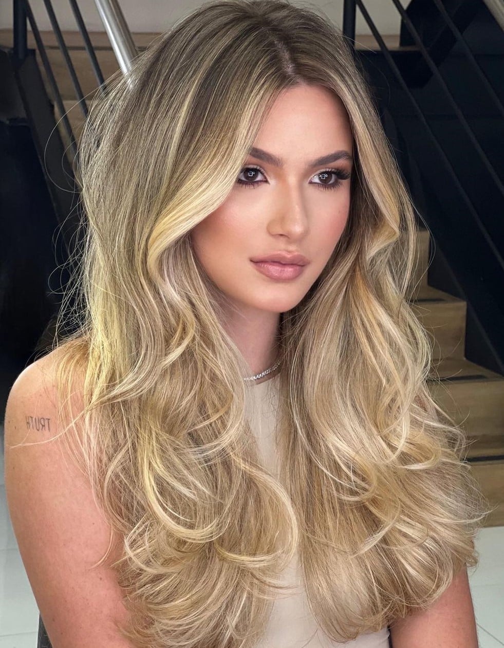 Mid-Back Blonde With Glossy Blowout and Curtain Bangs — Simple Highlights on Blonde Hair