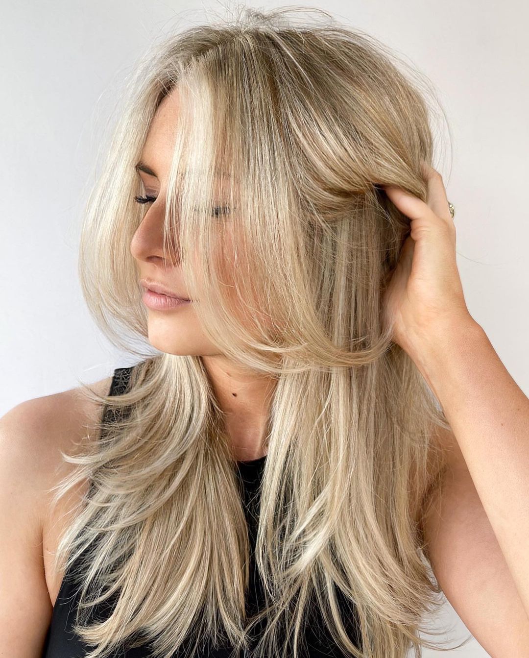 Collarbone Blonde With Curtain Bangs And Face-Framing, Close-Up Take — Simple Layered Haircuts for Long Hair