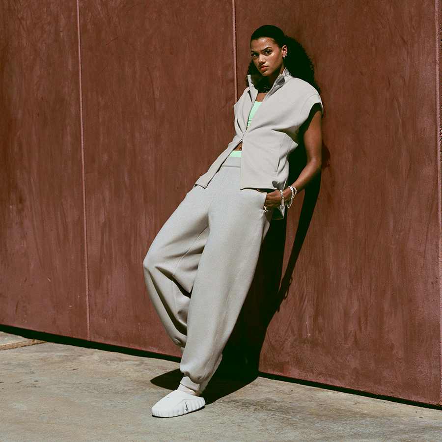 Grey Vest Over Neon Green Tank with Grey Tracksuit Pants — Simple Road Trip Outfits