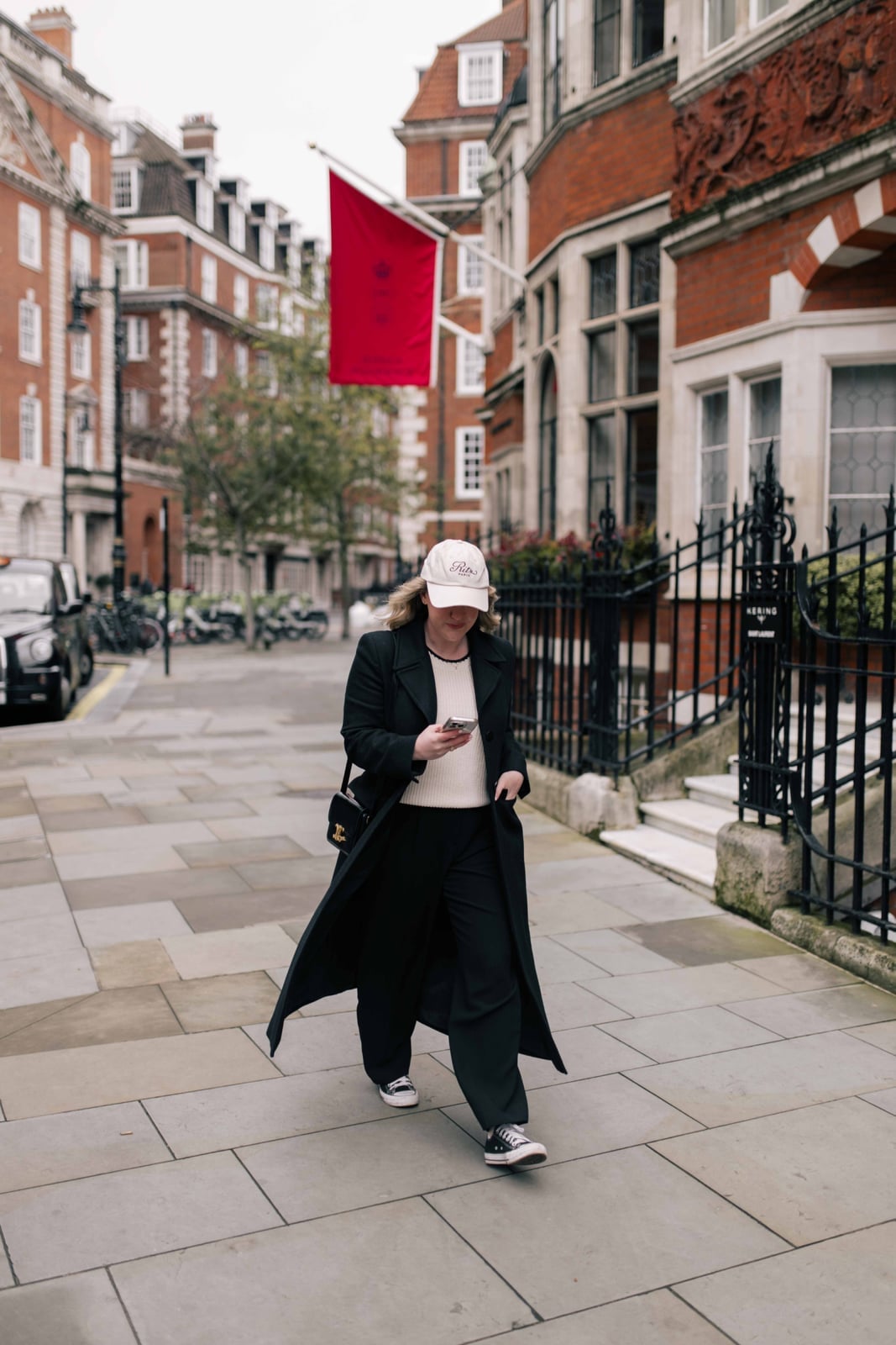 Long Black Coat Over Cream Sweater and Wide-Leg Trousers — Simple Road Trip Outfits