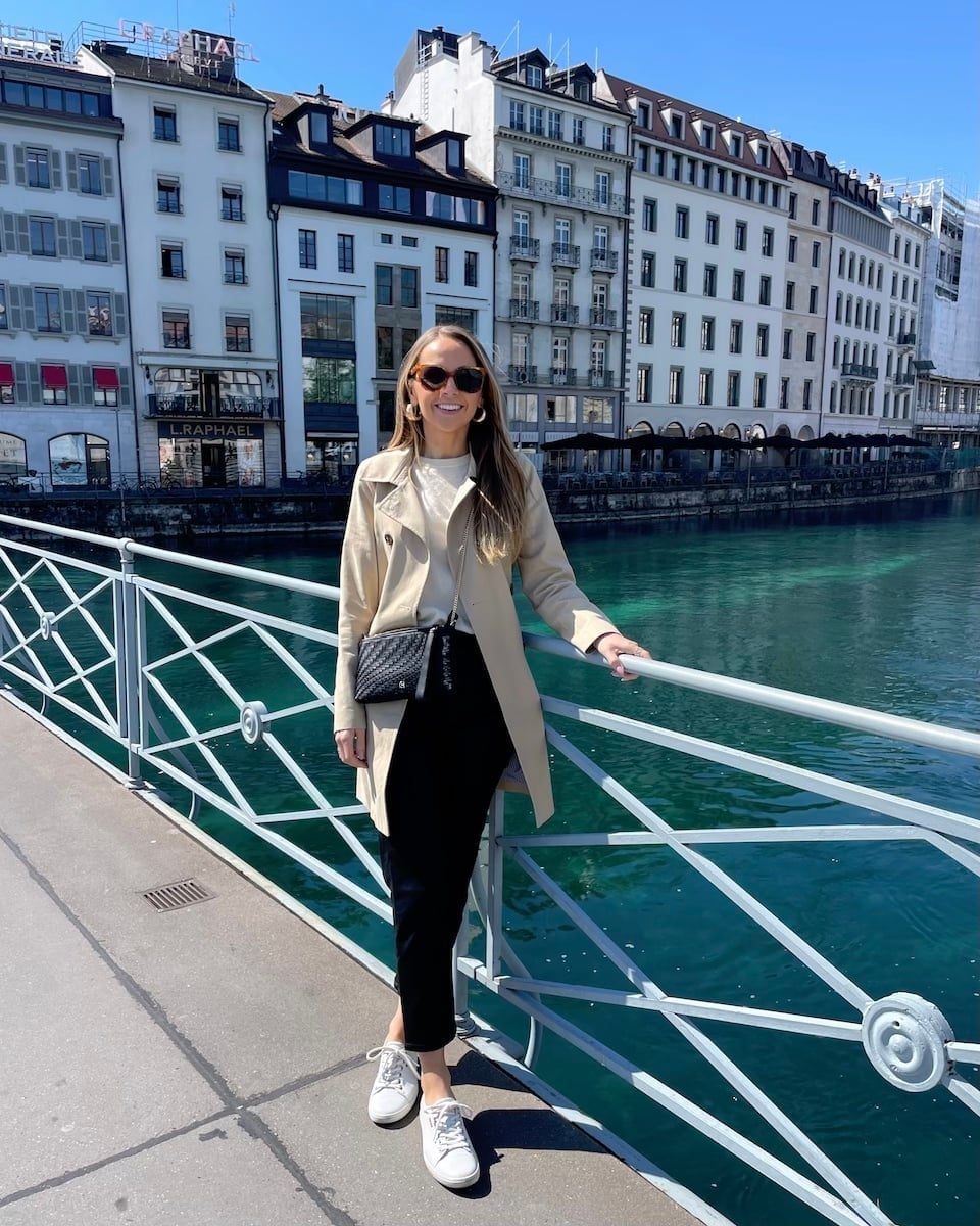 Beige Trench Coat Over Cream Top and Black Trousers — Simple Road Trip Outfits