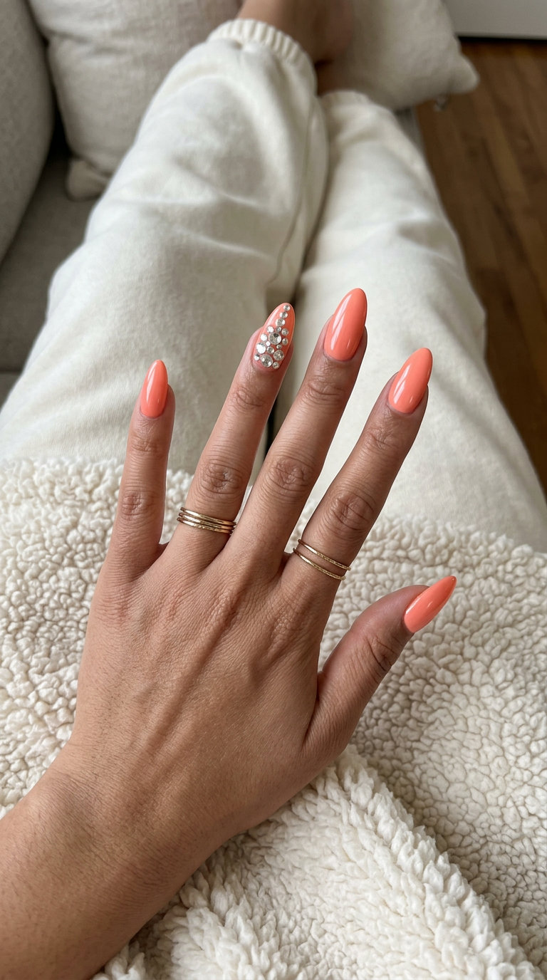 Glamorous Peach Rhinestone Nails 2026 Glamorous glossy peach nails with rhinestone accents for date night, summer peach nails 2026.