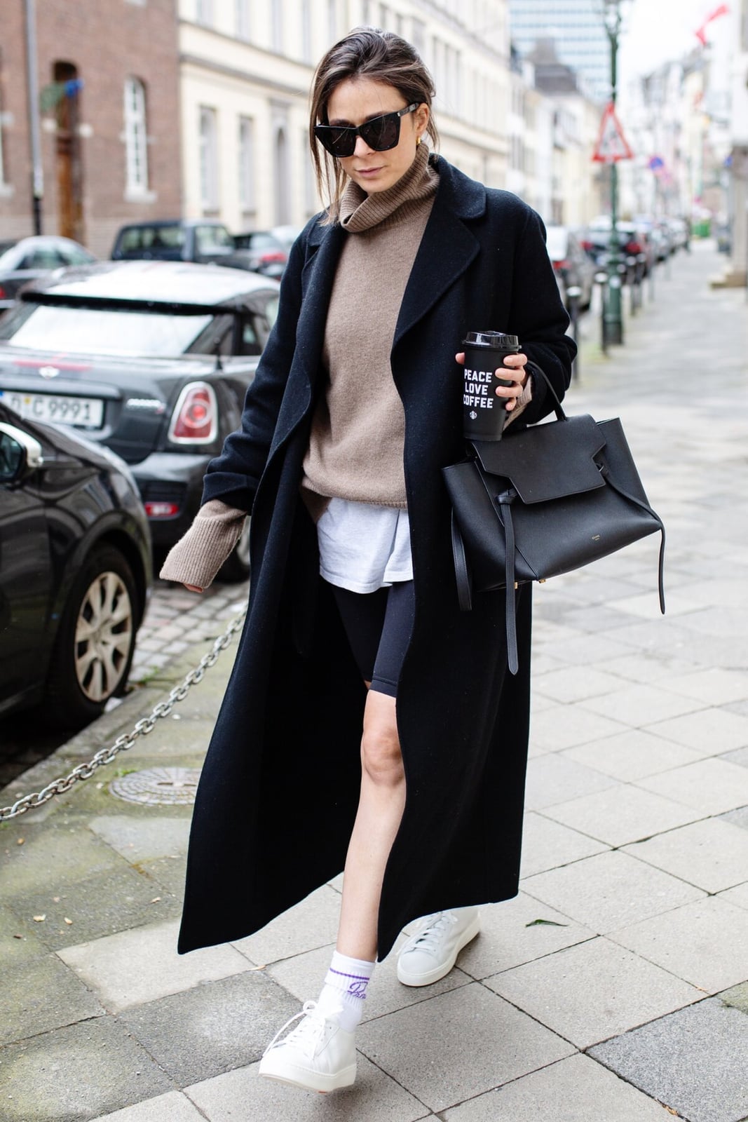 Black Maxi Coat Over Bike Shorts And Turtleneck — Trendy Athleisure Outfits