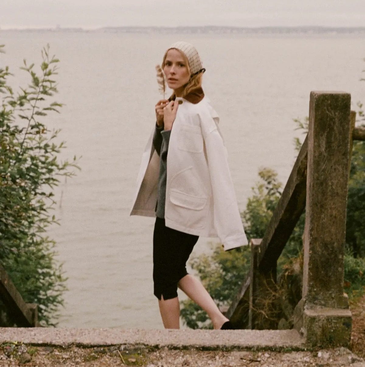 White Barn Jacket With Grey Sweater And Black Trousers — Trendy Barn Jacket Outfit