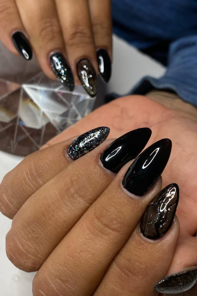 Glossy Black with Silver Glitter Accents — Trendy Black Almond Nails