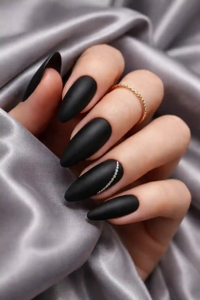 Matte Black Almond with Rhinestone Accent — Trendy Black Almond Nails