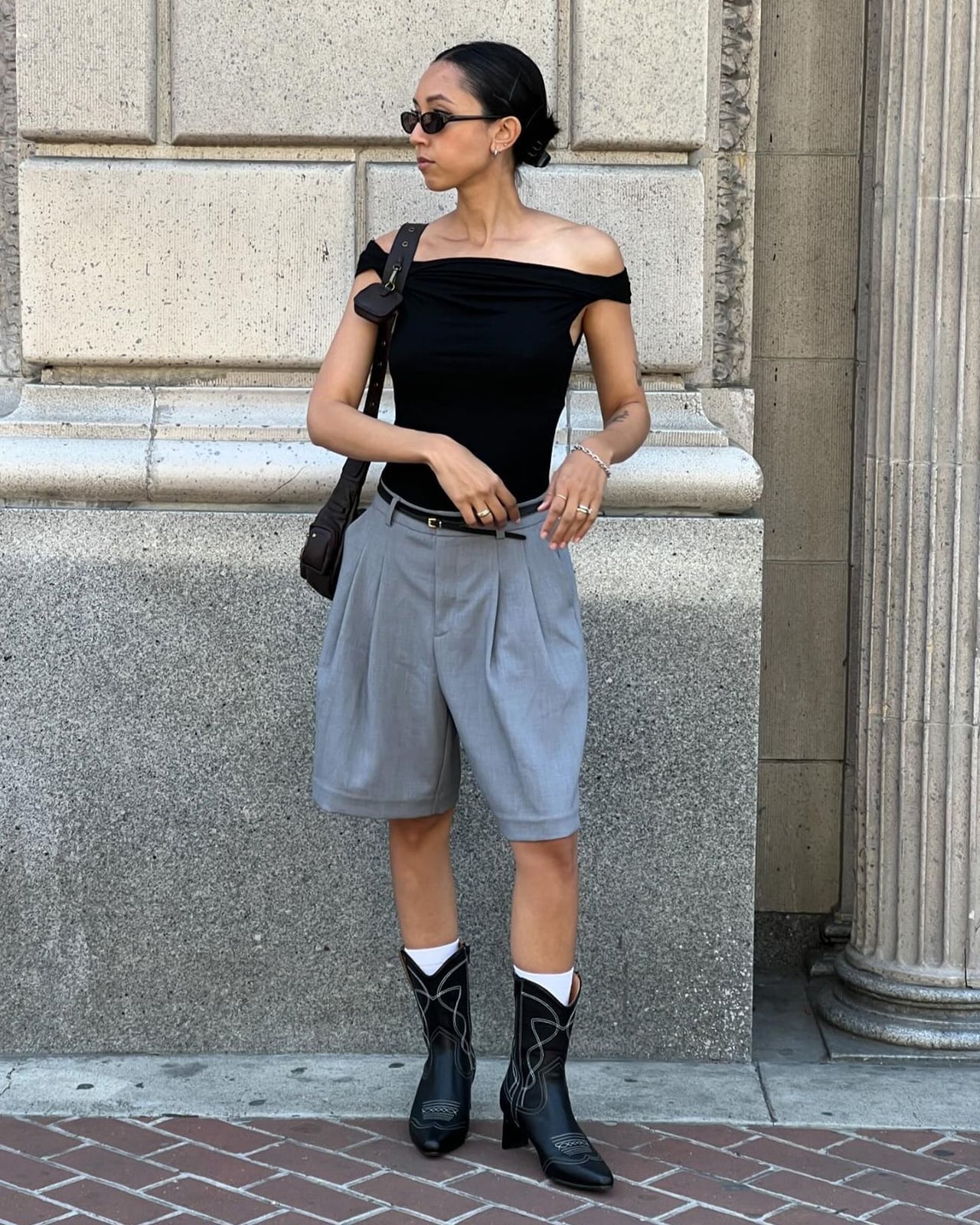 Black Cowboy Boots with Grey Wide-Leg Shorts and Off-The-Shoulder Top — Trendy Black Cowboy Boots Outfit