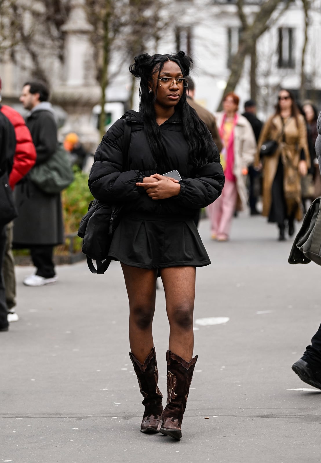 Brown Embroidered Cowboy Boots with Black Mini Skirt and Puffer Jacket — Trendy Black Cowboy Boots Outfit