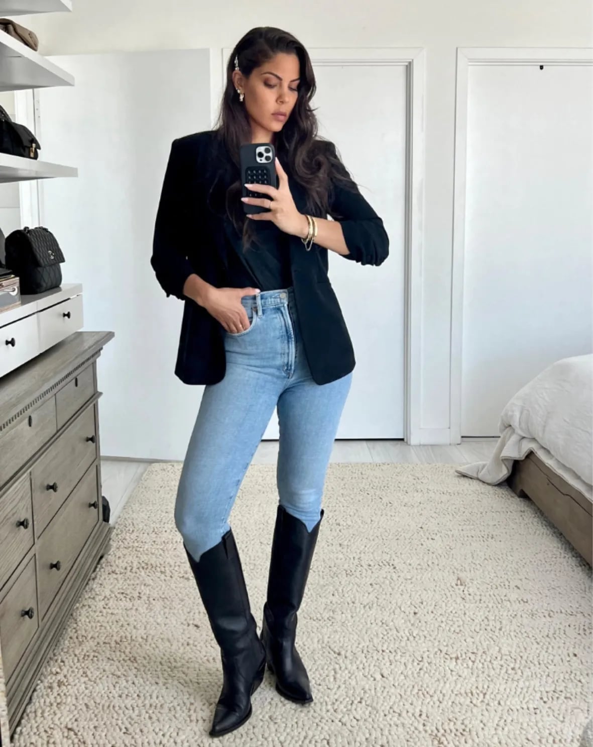 Black Knee-High Cowboy Boots with Fitted Jeans and Oversized Blazer — Trendy Black Cowboy Boots Outfit