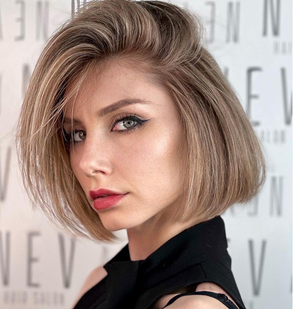 Honey Blonde Bob With Side-Swept Bangs Honey Blonde Bob With Side-Swept Bangs — Trendy Blonde Short Hair