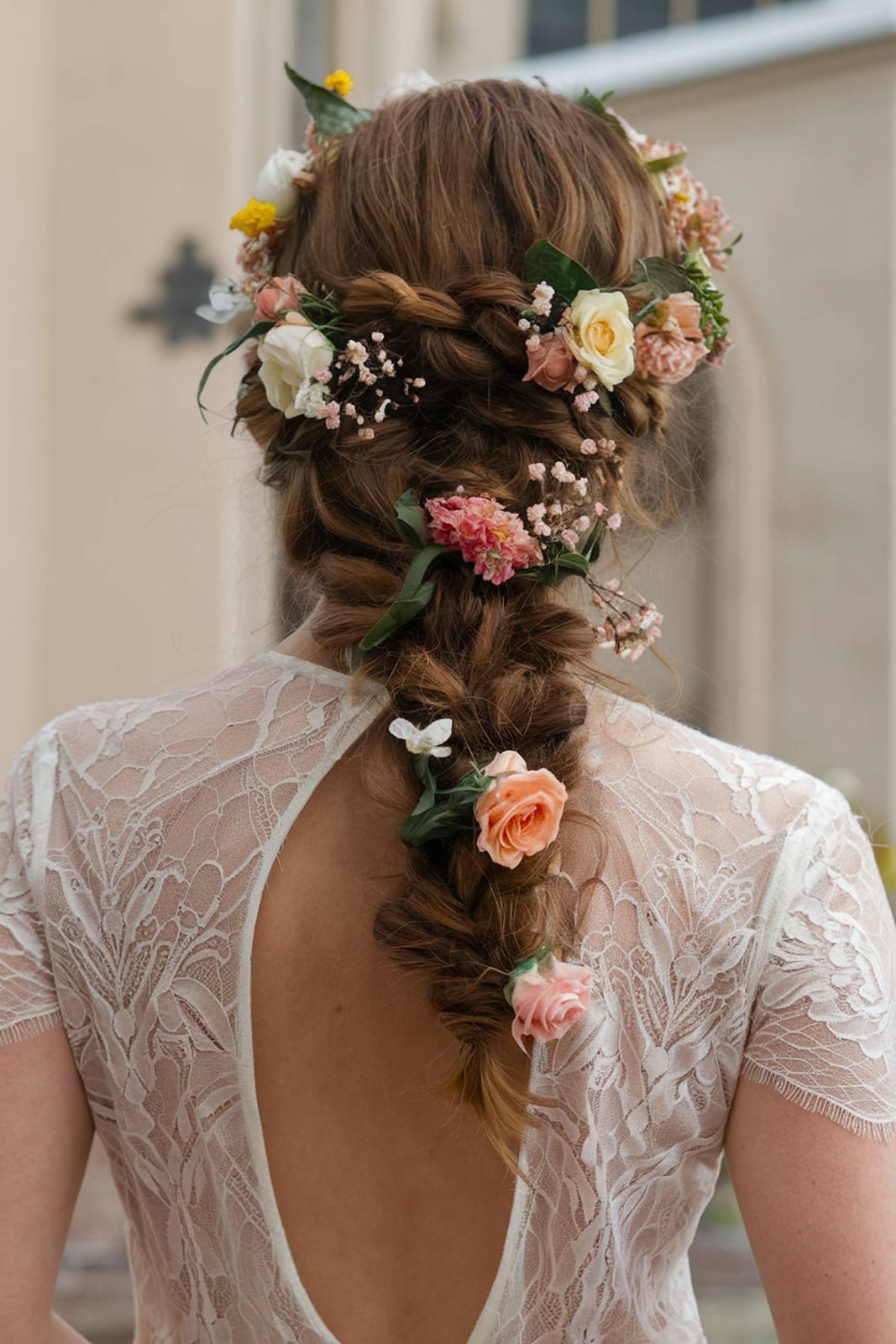 Mid-Back Fishtail Braid With Flowers Mid-Back Fishtail Braid With Flowers — Trendy Bridal Hair