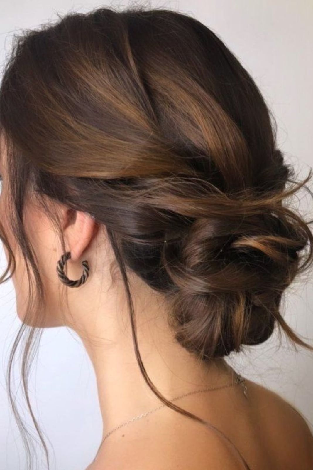 Low Messy Bun With Soft Tendrils Low Messy Bun With Soft Tendrils — Trendy Bridesmaid Hairstyles Updo