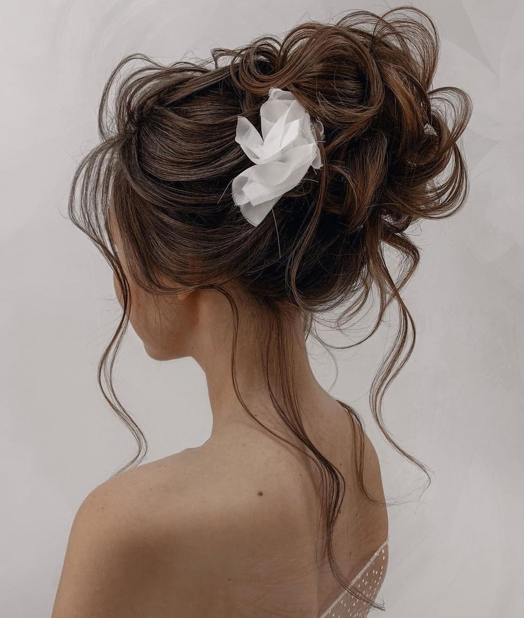 Messy High Updo With Flower Accent Messy High Updo With Flower Accent — Trendy Bridesmaid Hairstyles Updo