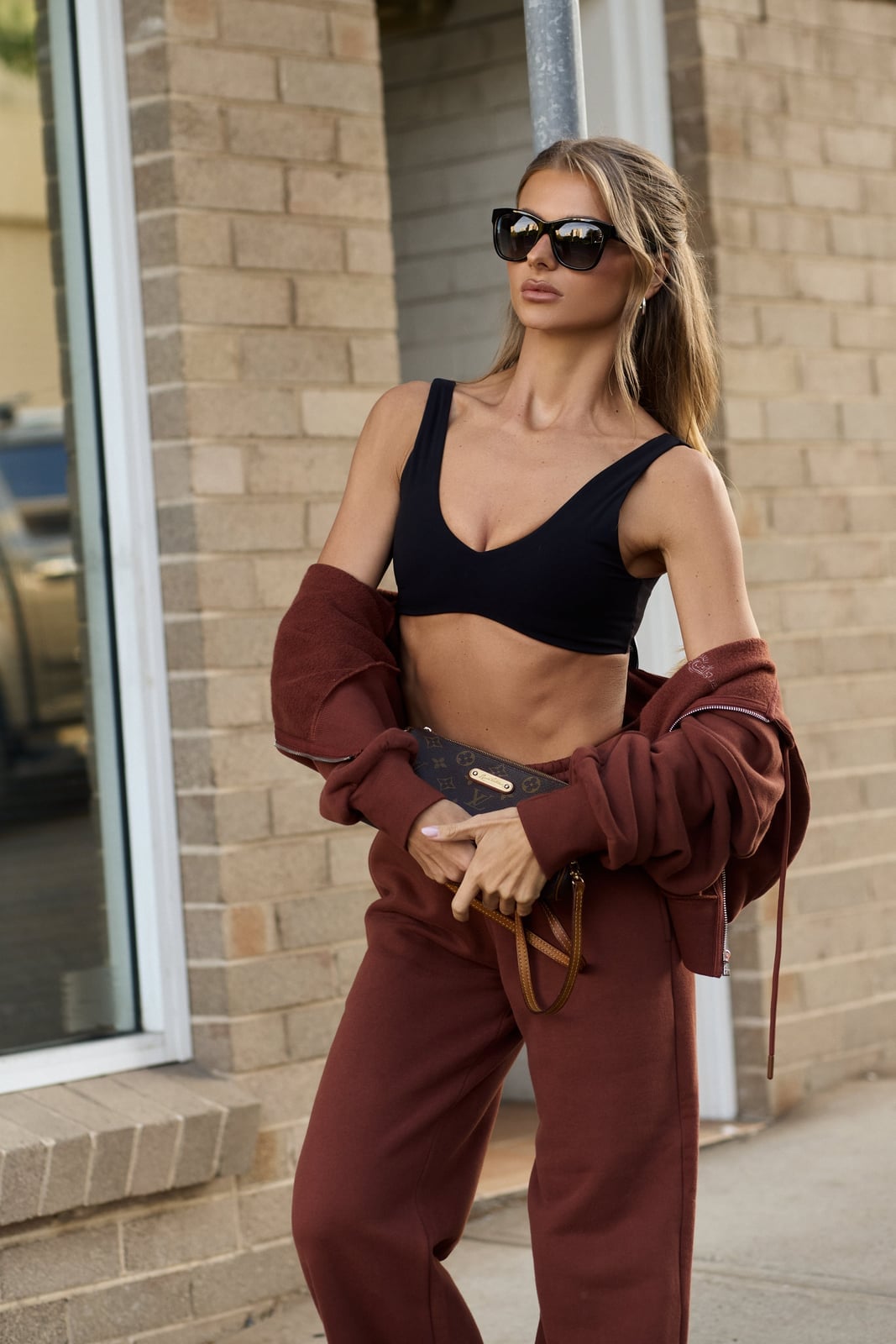 Brown Hoodie With Black Bralette And Clutch — Trendy Brown Hoodie Outfit