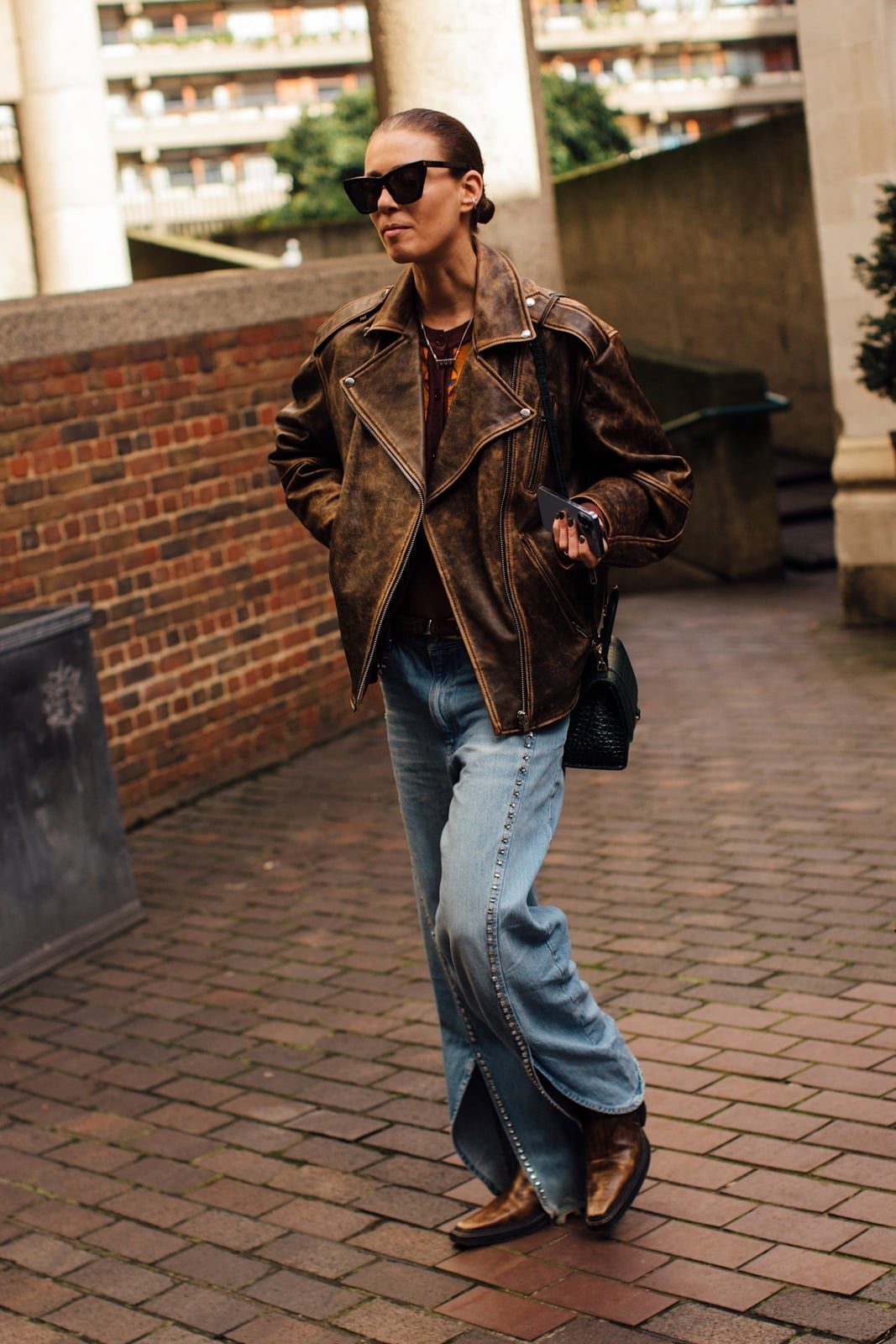 Distressed Leather Jacket With Cowboy Boots — Trendy Brown Jacket Outfit