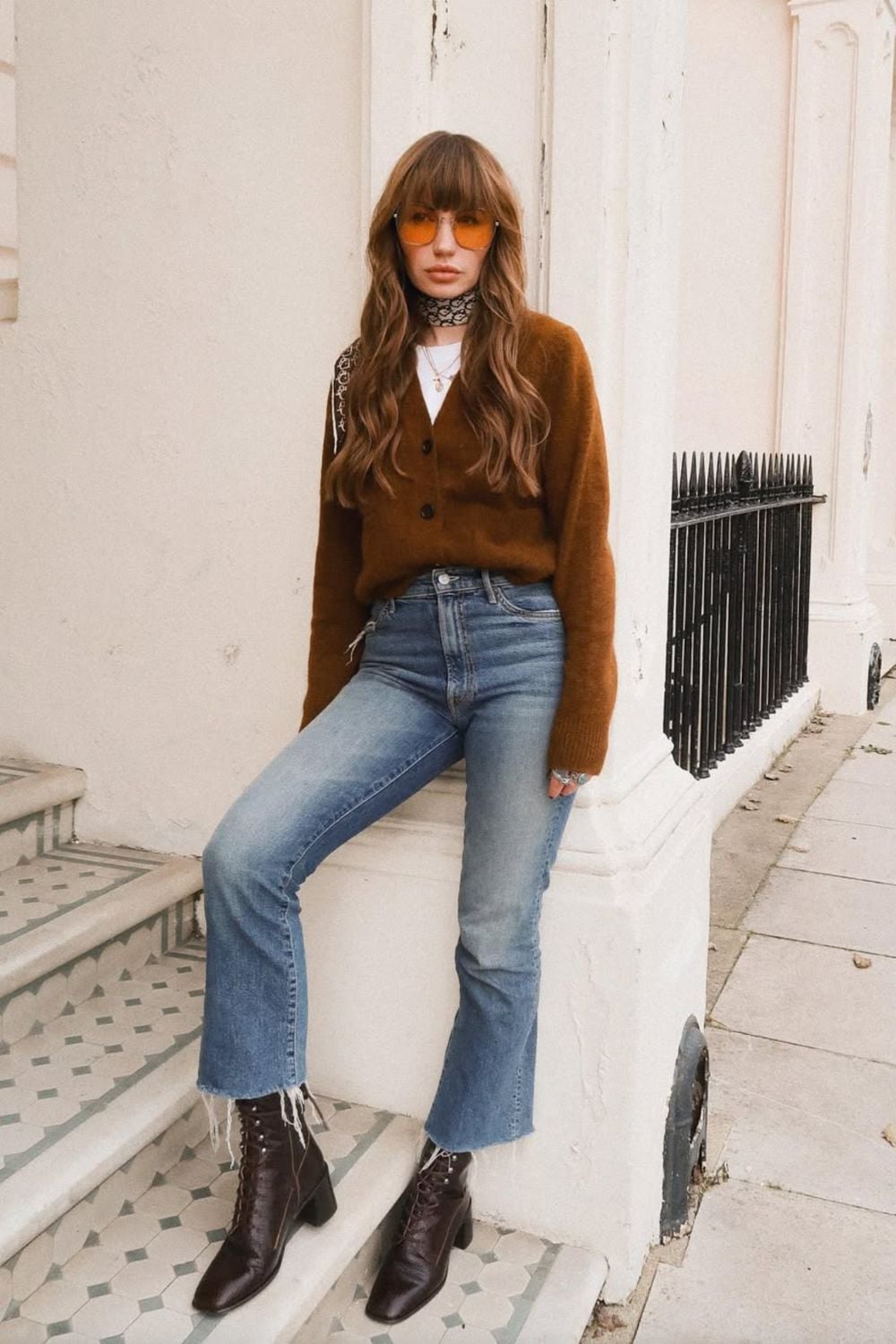 Brown Knit Cardigan Over White T-Shirt with Flared Jeans — Trendy Brown Sweater Outfit