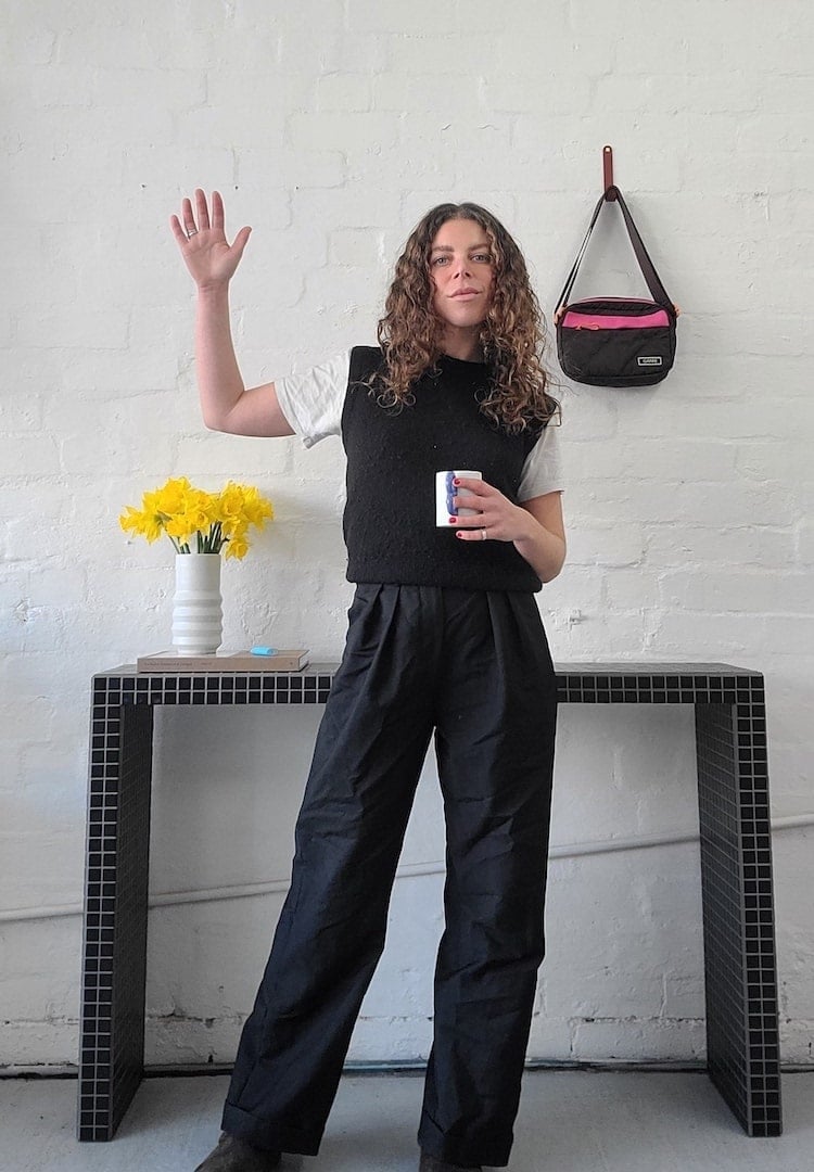 Black Sleeveless Vest Over Grey T-Shirt and Wide-Leg Trousers Black Sleeveless Vest Over Grey T-Shirt and Wide-Leg Trousers — Trendy Business Professional Outfits