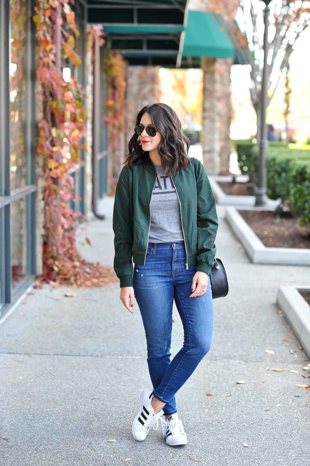Bomber Jacket with Graphic T-Shirt and Fitted Jeans — Trendy College Outfits